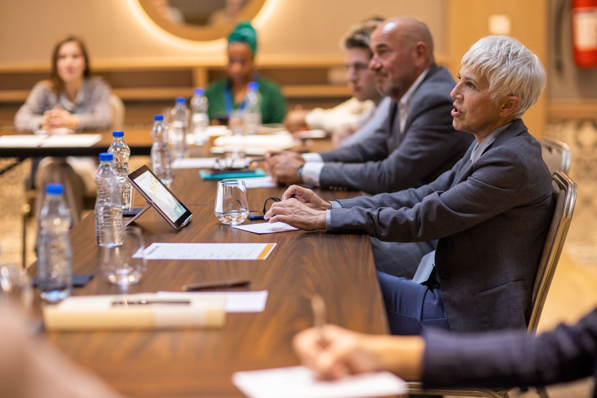 Group of Board members discussing ideas during meeting.
