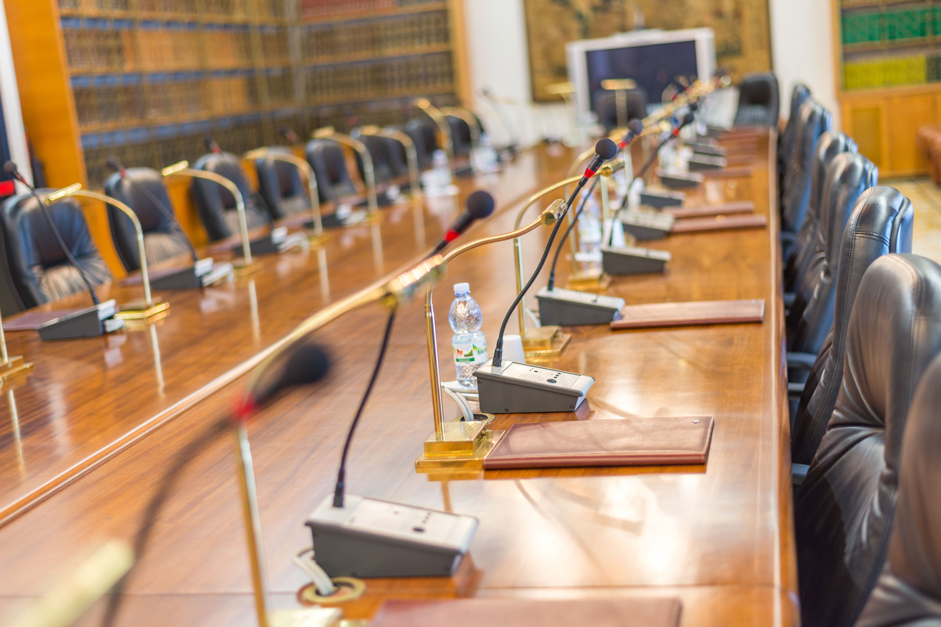 Where-Are-the-Boards Empty board meeting room with mics.
