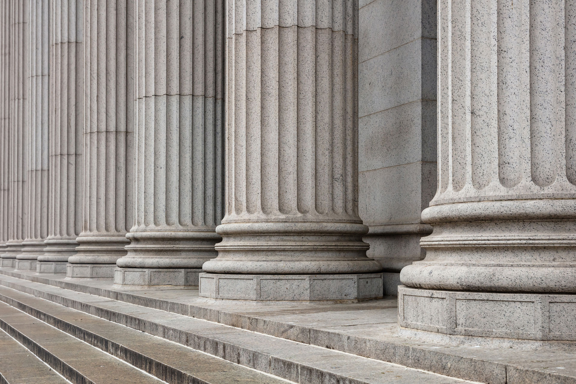 Key-Governance-Resources-for-Trustees Stone pillars on stairs to building.