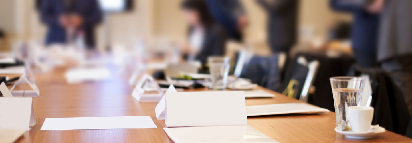 board members around the table in conference room.