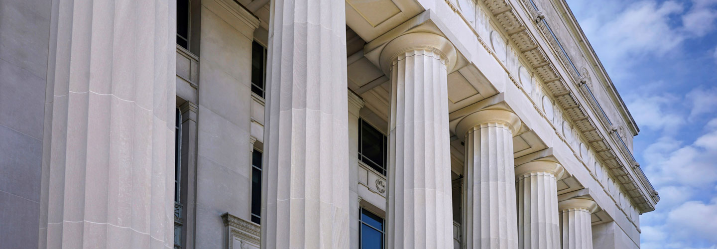 Entrance to classical style university building with doric columns.